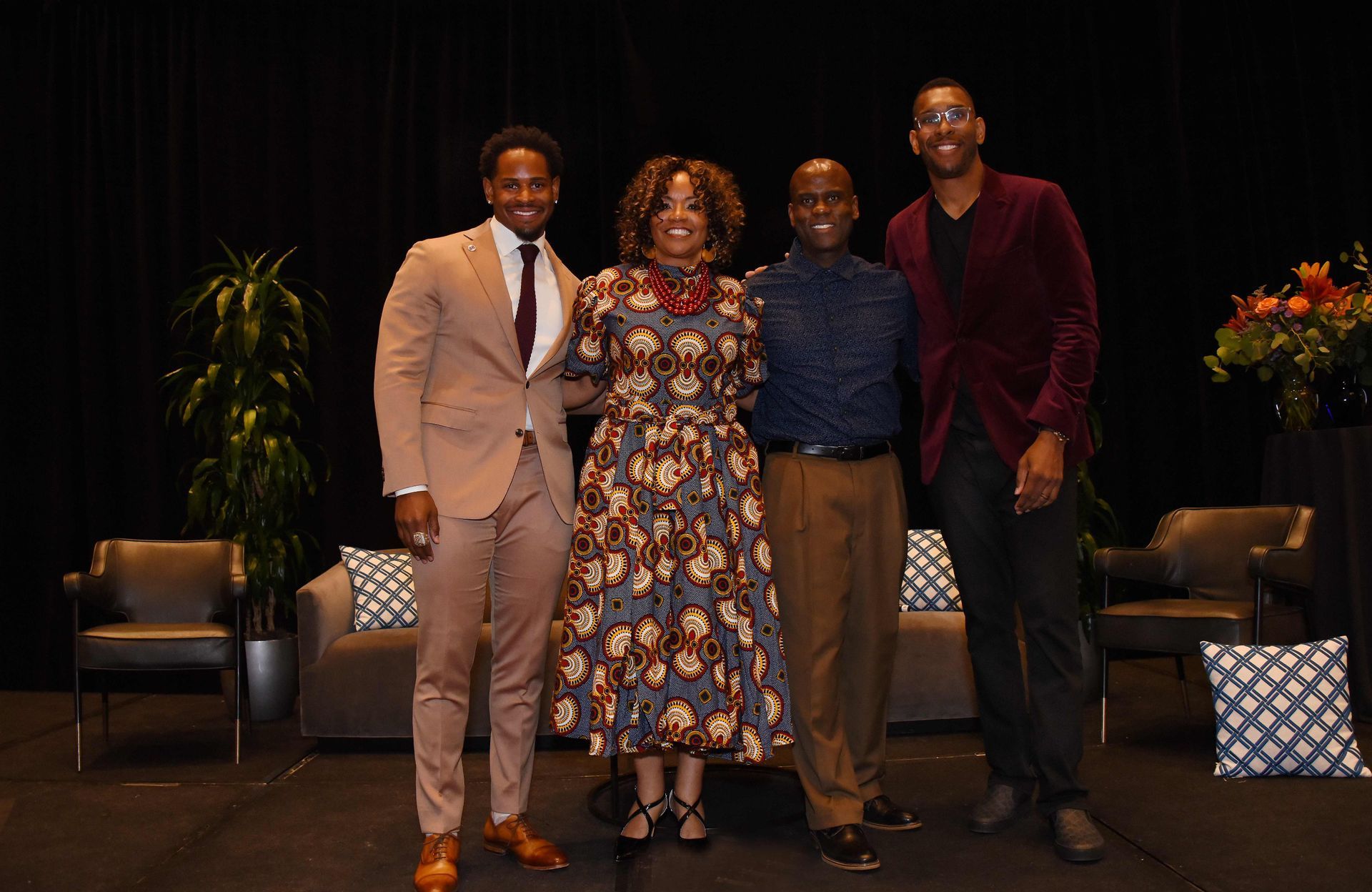 A group of people are posing for a picture on a stage.