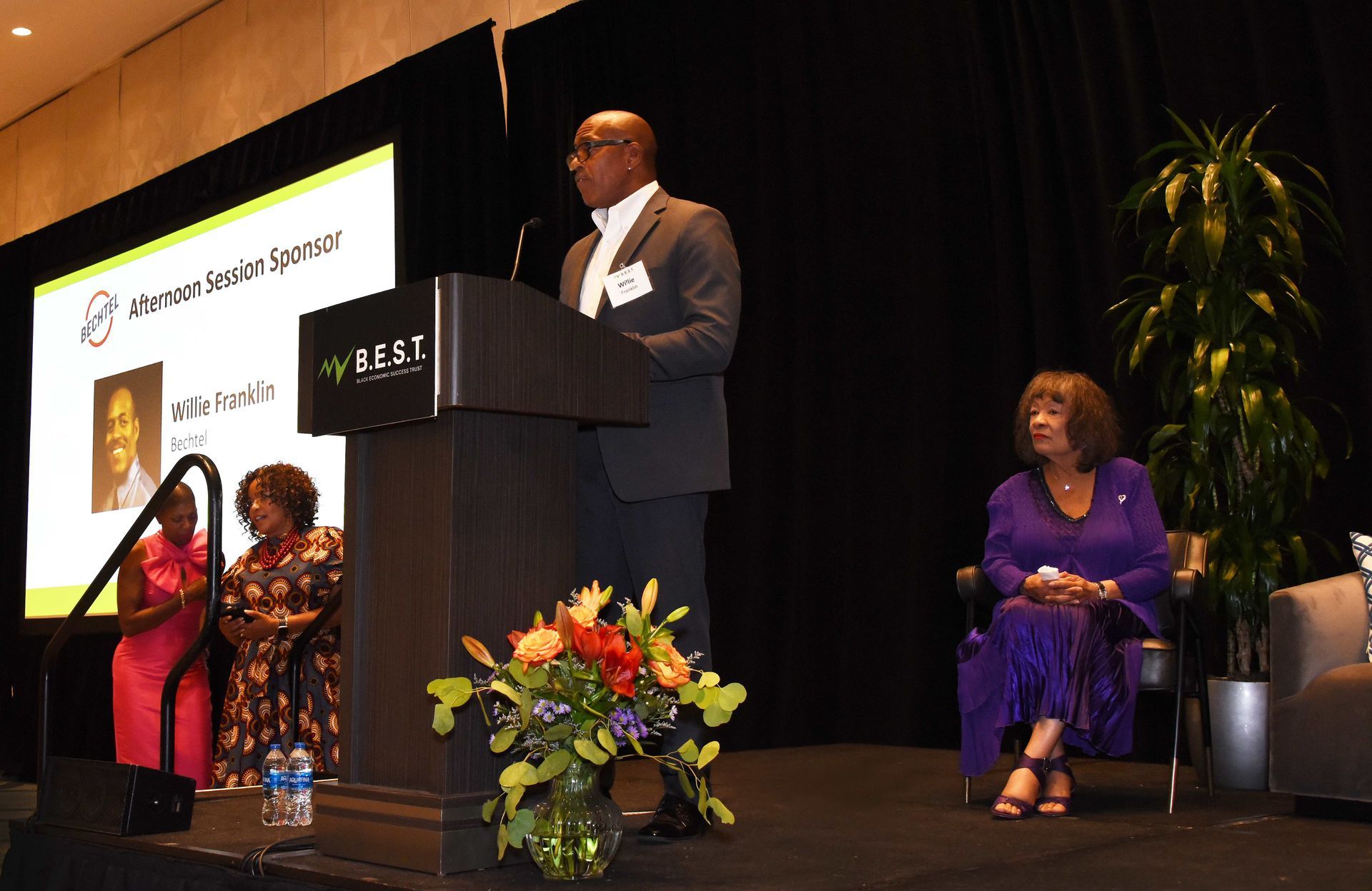 A man is standing at a podium giving a speech