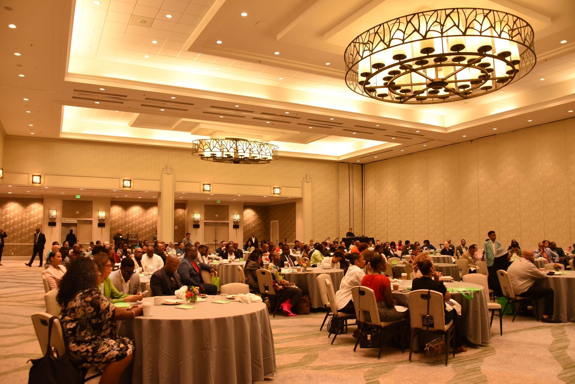 A large room with tables and chairs and a large chandelier