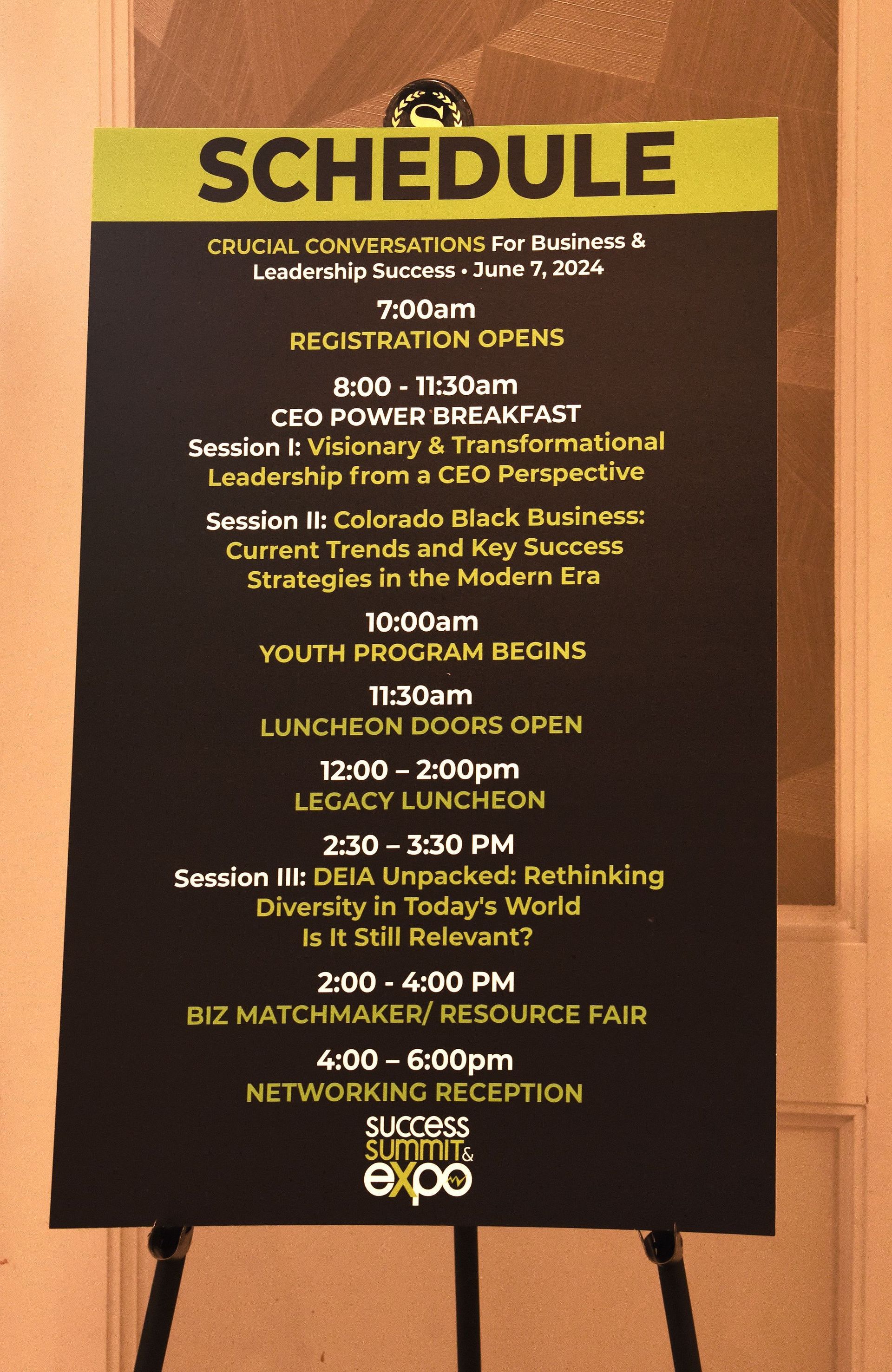 A schedule for a conference is displayed on an easel