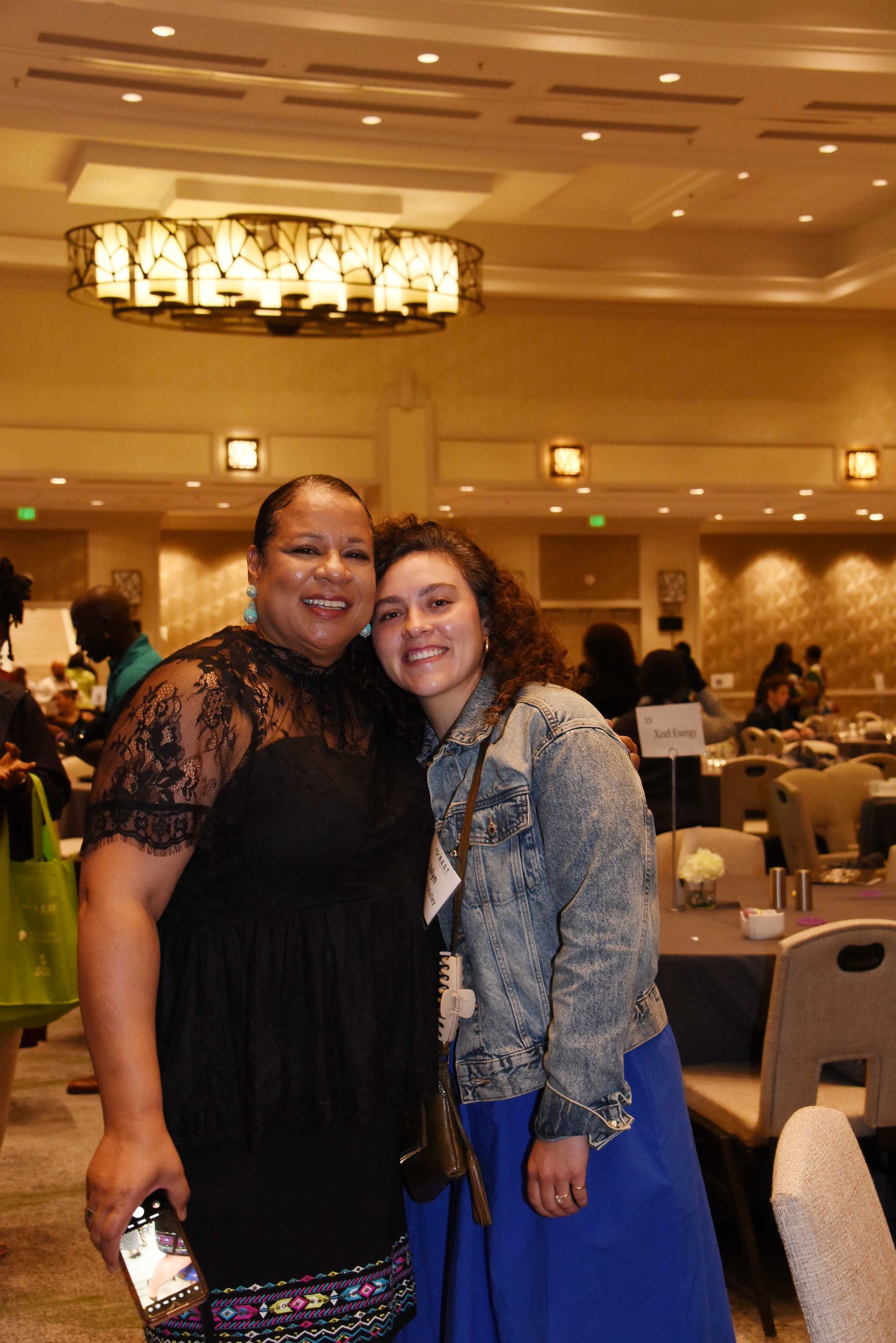 Two women are posing for a picture in a room.