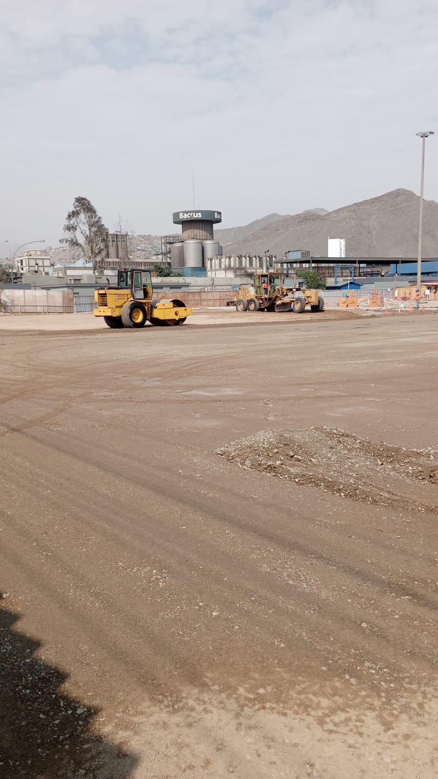 Un par de tractores circulan por un camino de tierra.