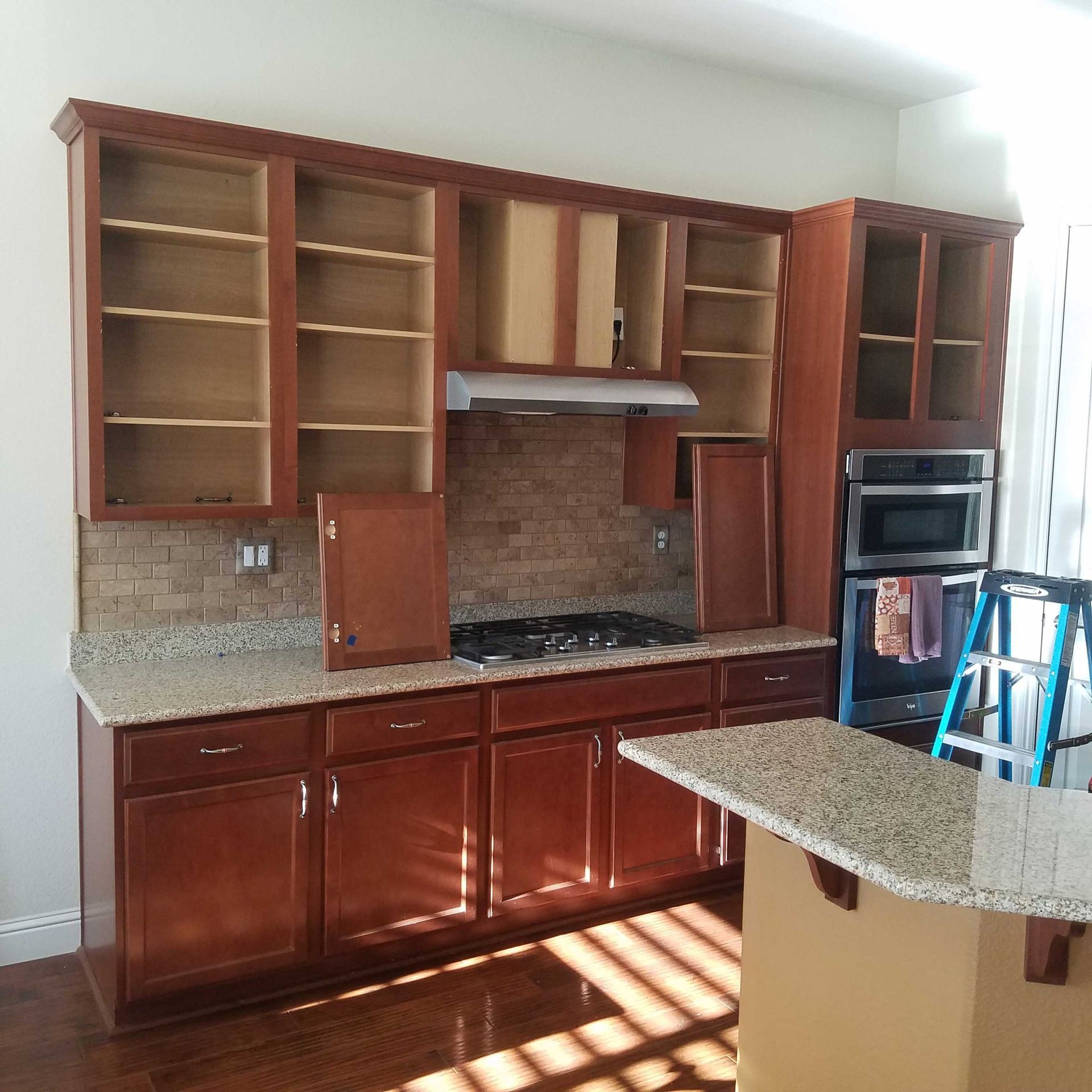 A kitchen with wooden cabinets and granite counter tops