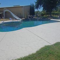 A large swimming pool with a slide in the middle of it.