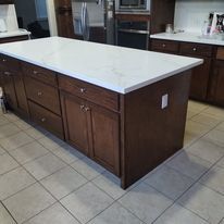 There is a large island in the middle of the kitchen.