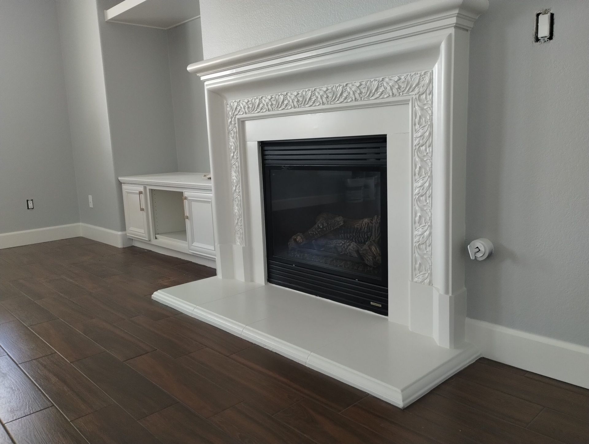 A white crib is sitting in a nursery next to a plant.
