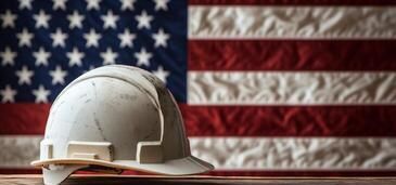 White hard hat in front of the American flag.
