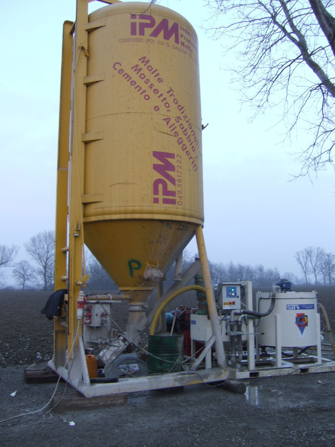 Un grande silo giallo con la scritta ipm sopra