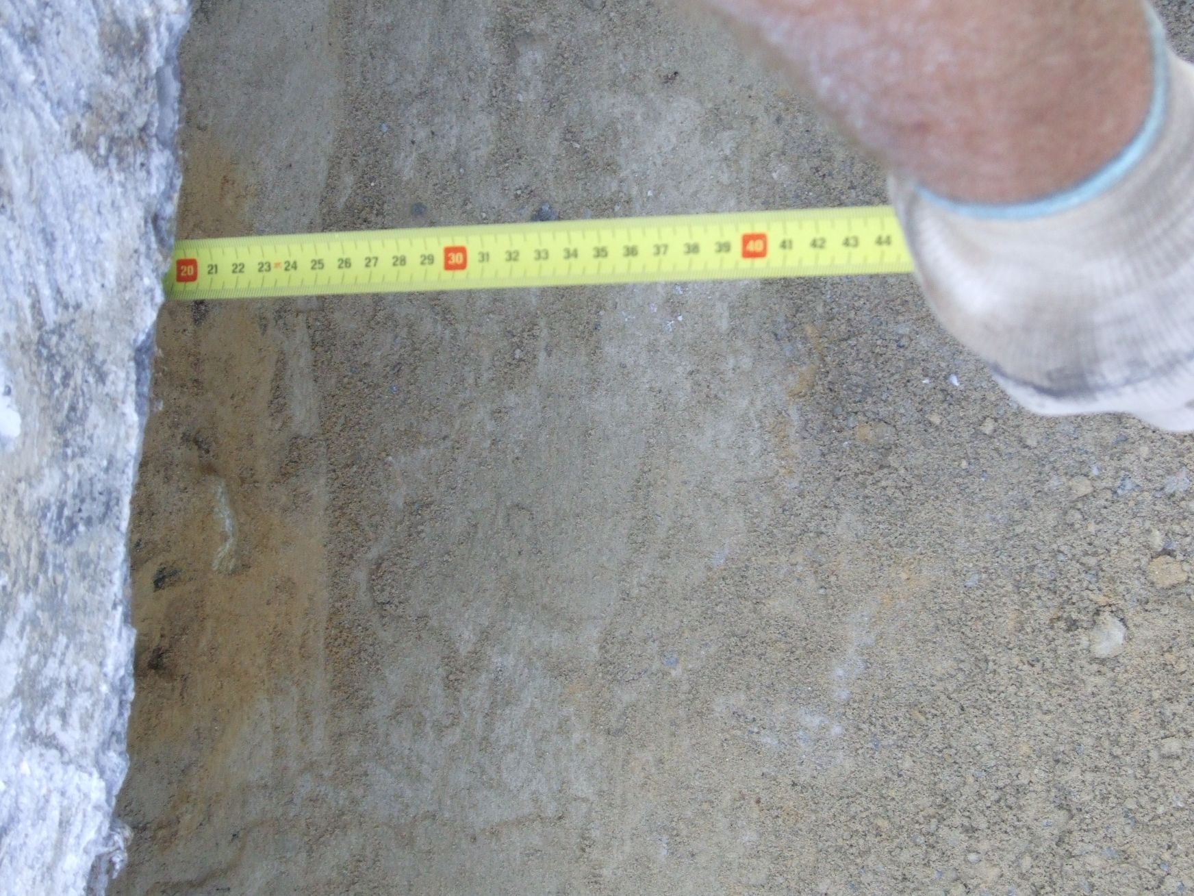 Una persona sta misurando un muro con un metro a nastro