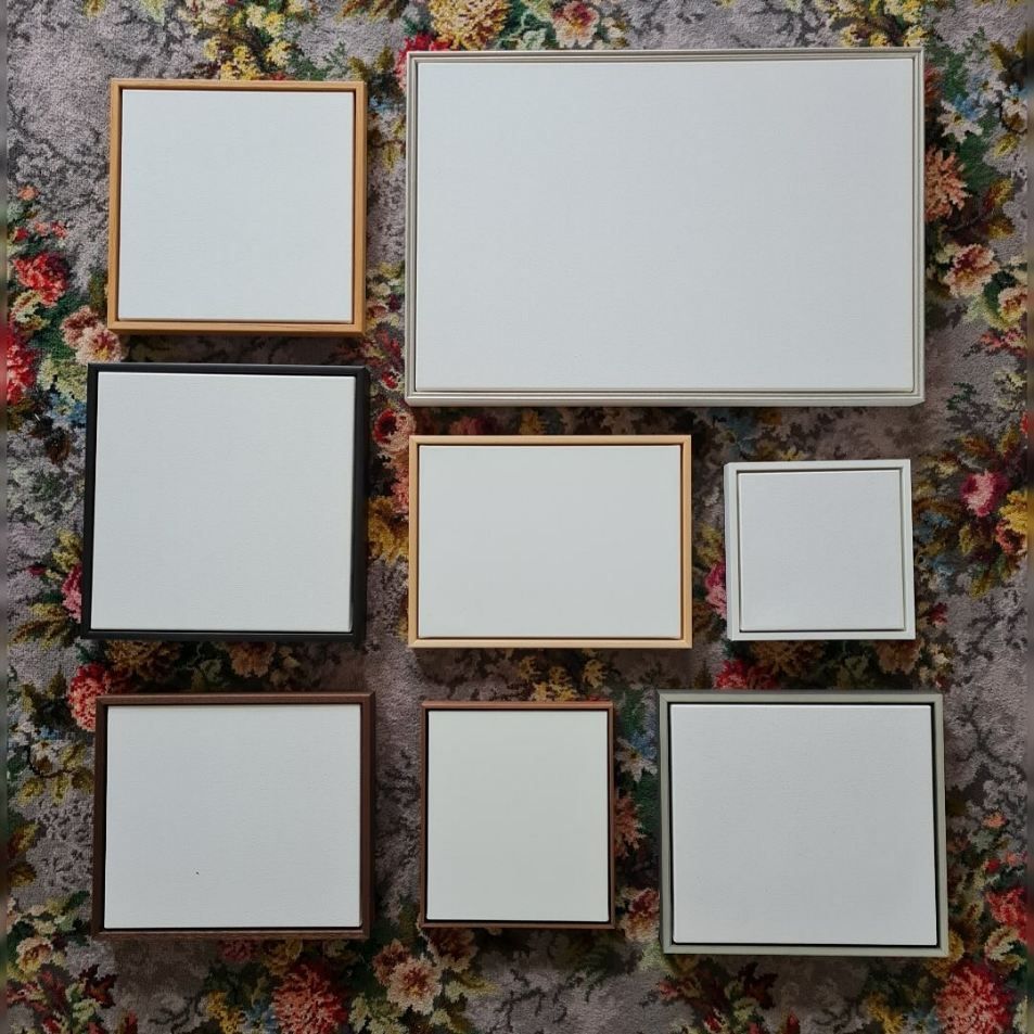 A Group of Square Frames Are Sitting on a Floral Carpet — Next Level Picture Framing In Ballina, NSW