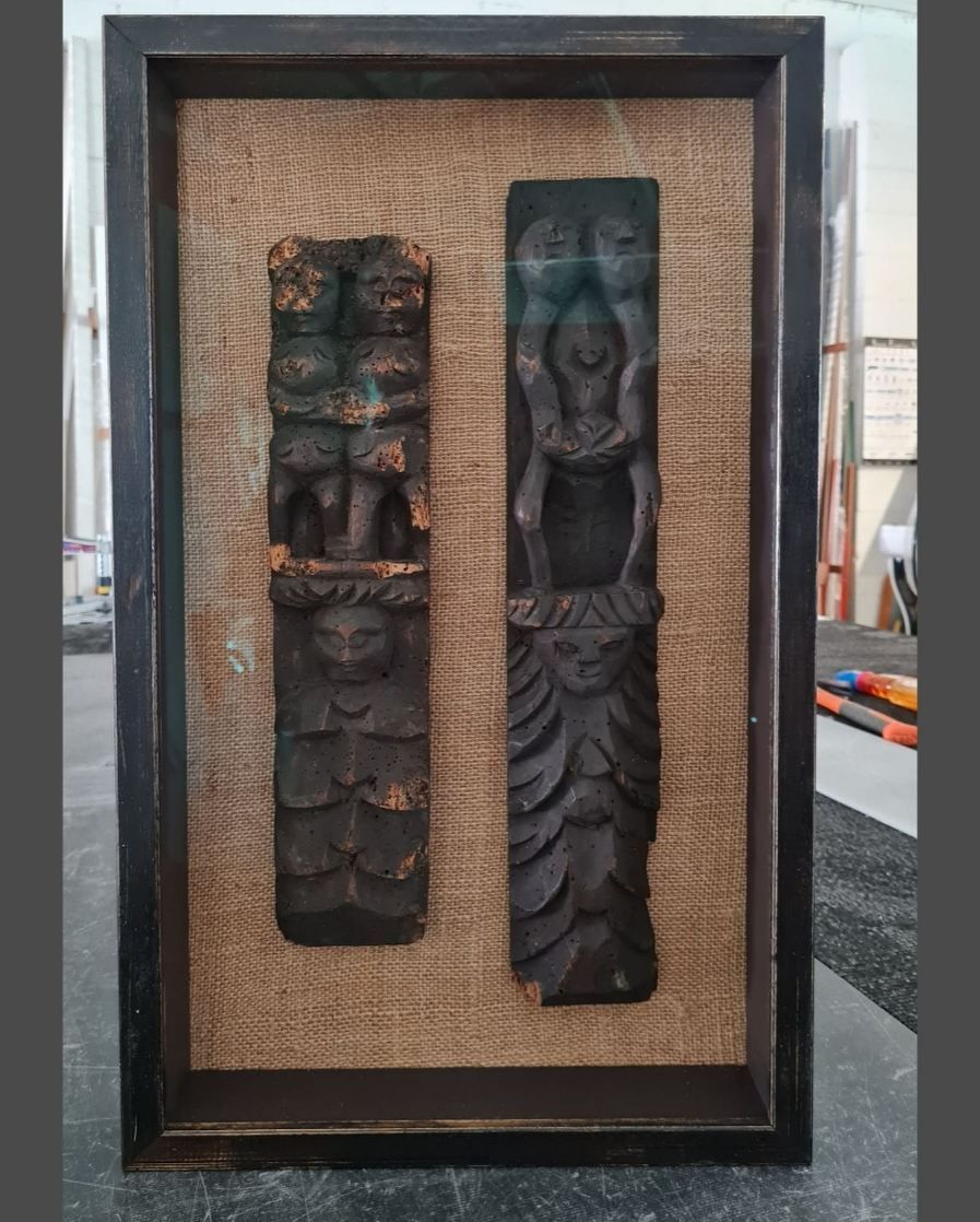 A Picture of Two Carvings in a Frame on a Wall — Next Level Picture Framing In Ballina, NSW