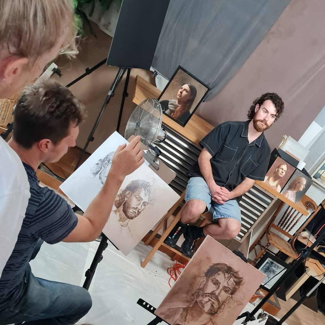 A Man is Drawing a Picture of a Man on a Canvas — Next Level Picture Framing In Ballina, NSW