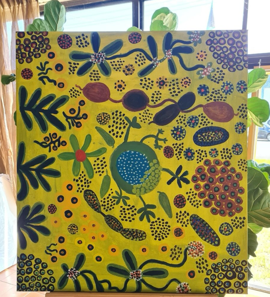 A yellow canvas painting with flower like designs — Next Level Picture Framing In Ballina, NSW
