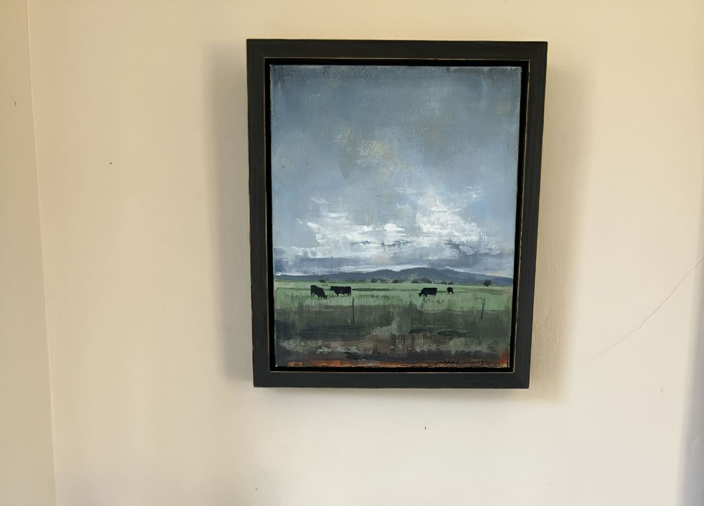 A Painting is Hanging on a Wall Above a Vase of Flowers on a Table — Next Level Picture Framing In Ballina, NSW