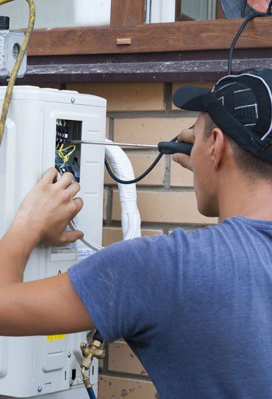 Man Repairs the Air Conditioner — Richland, PA — New Aire Tech LLC