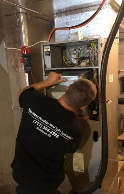 Man Installing New Heating System — Richland, PA — New Aire Tech LLC