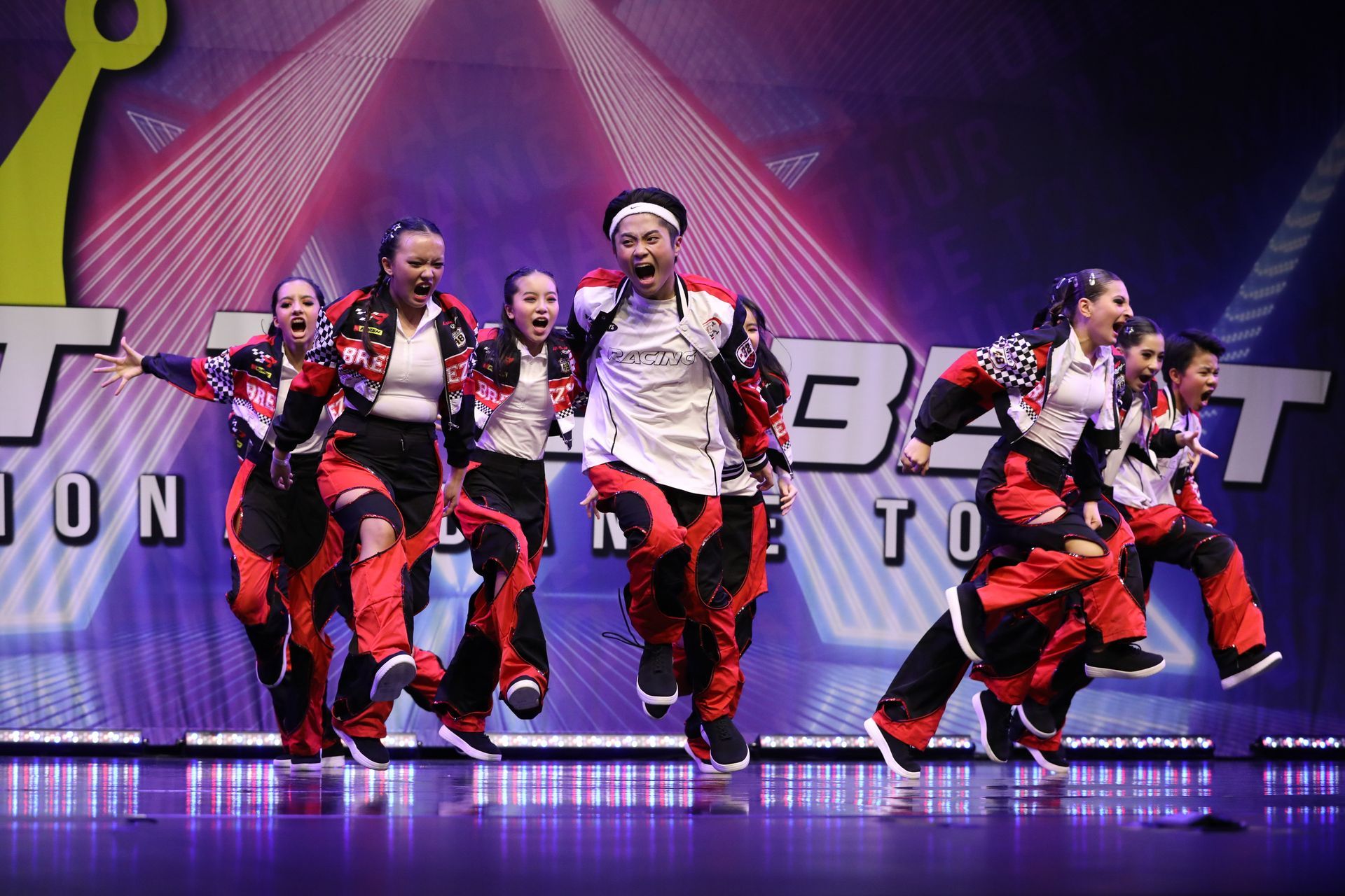 A group of dancers are performing on a stage.