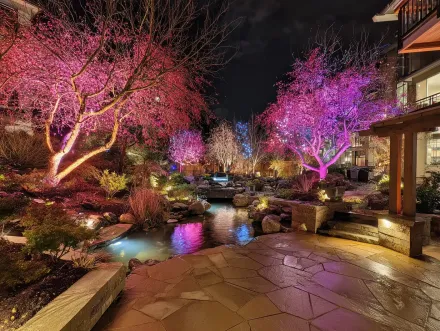 A magical garden illumination project in Burnaby. This landscape lighting Burnaby design features LED spotlights highlighting plants and flowers. For custom outdoor lighting, our Burnaby BC services are unmatched. The low voltage system provides a soft glow, transforming this backyard into an oasis. Keywords: Burnaby landscape lighting, garden lighting Burnaby, professional installation, curb appeal, exterior home design, Willingdon Heights, low voltage lighting solutions Burnaby.