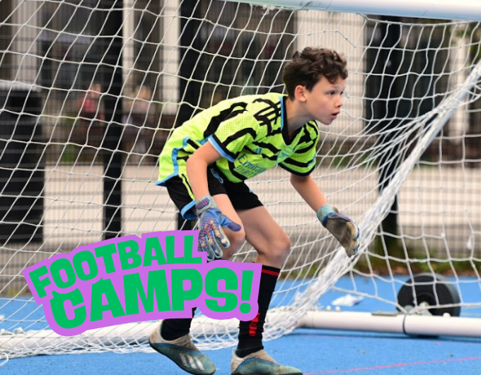 Girls soccer team sitting on grass together