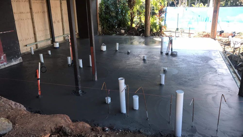 Freshly Poured Concrete Floor With Plumbing Pipes at a Construction Site — JDC Concreting in Grafton, NSW