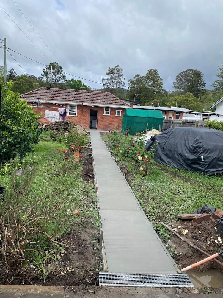 Newly Poured Concrete Walkway Leading to a Brick House — JDC Concreting in Ballina, NSW