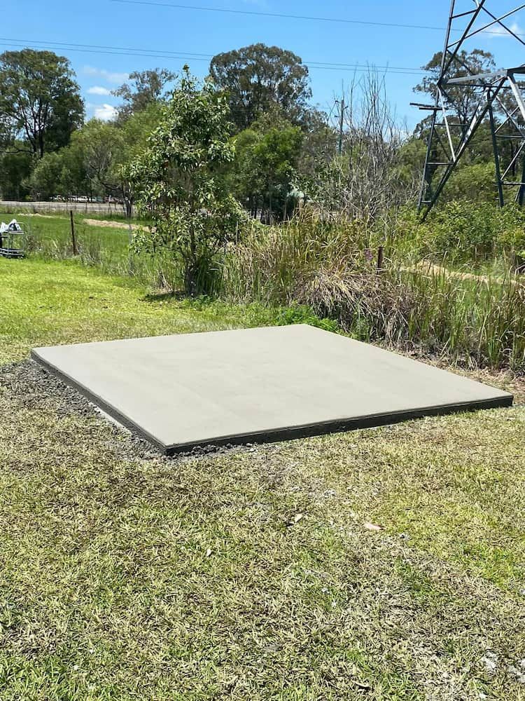 Square Concrete Pad on Grassy Ground, Trees and Power Lines — JDC Concreting in Grafton, NSW