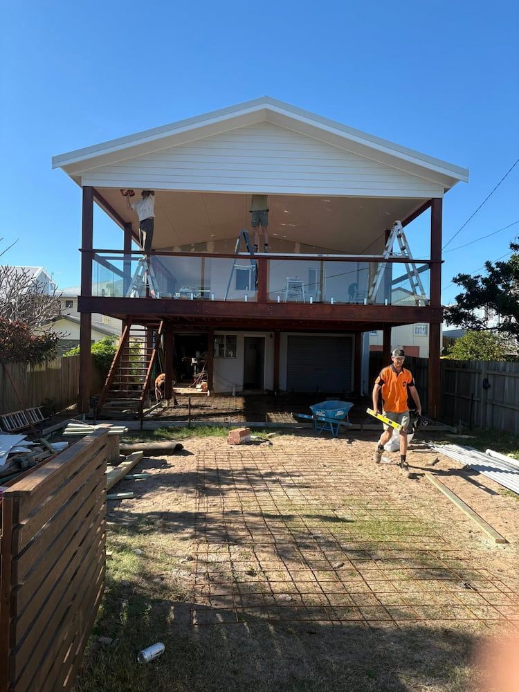 Construction Site: Two-story House With Deck, Workers, and a Concrete Foundation in Progress — JDC Concreting in Grafton, NSW