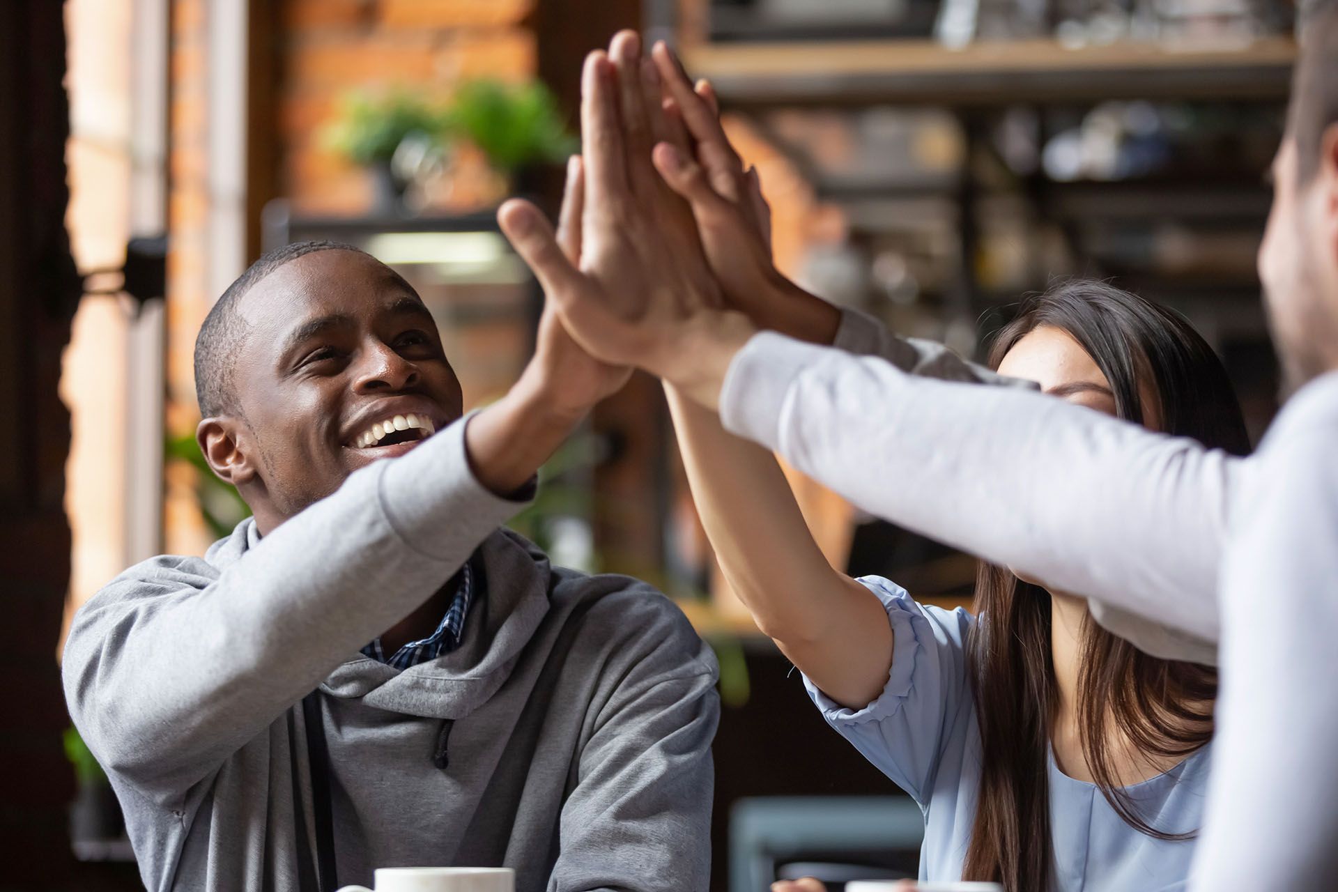 A group of people are giving each other a high five.