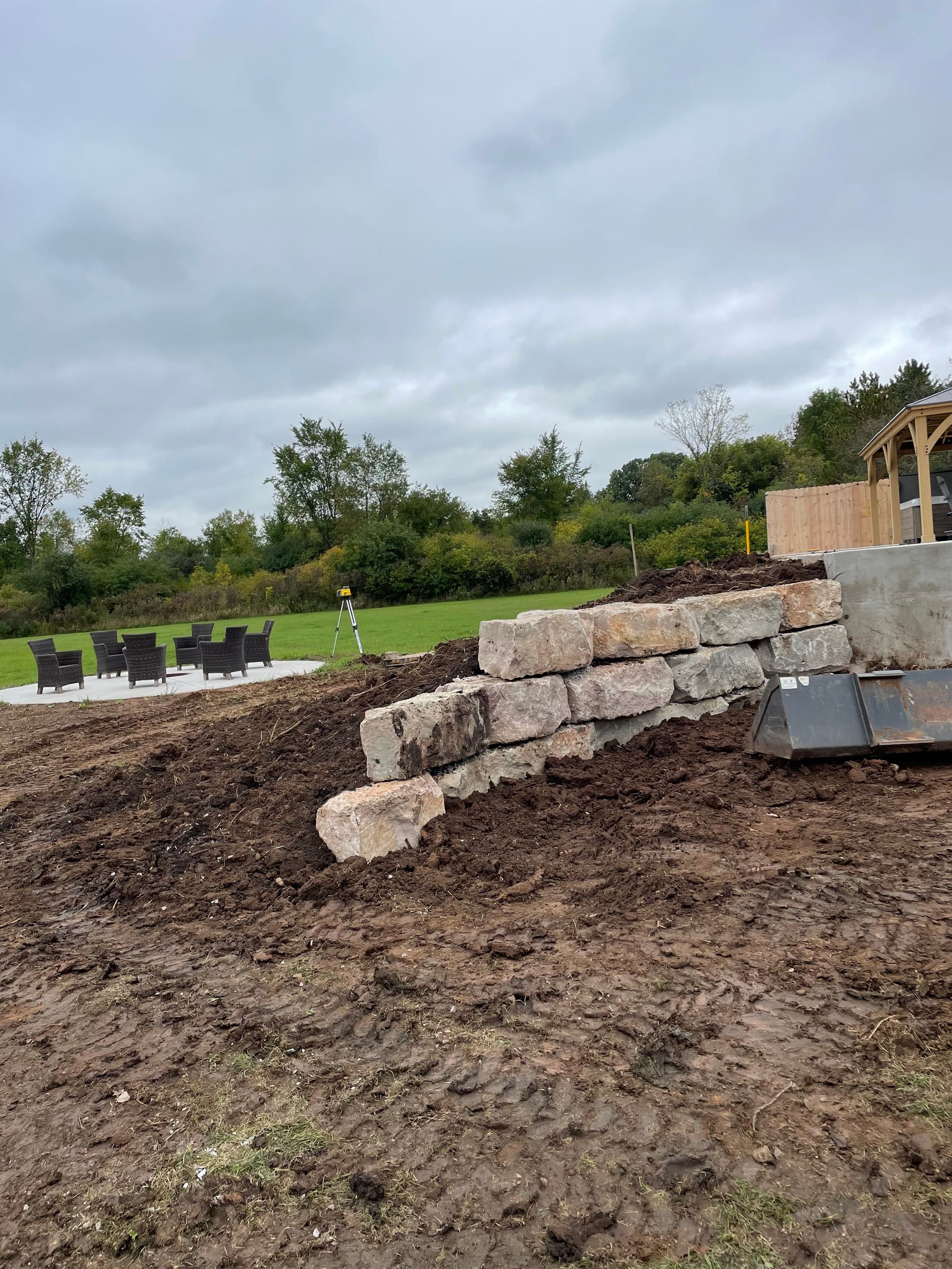 A large pile of dirt is sitting in the middle of a field.