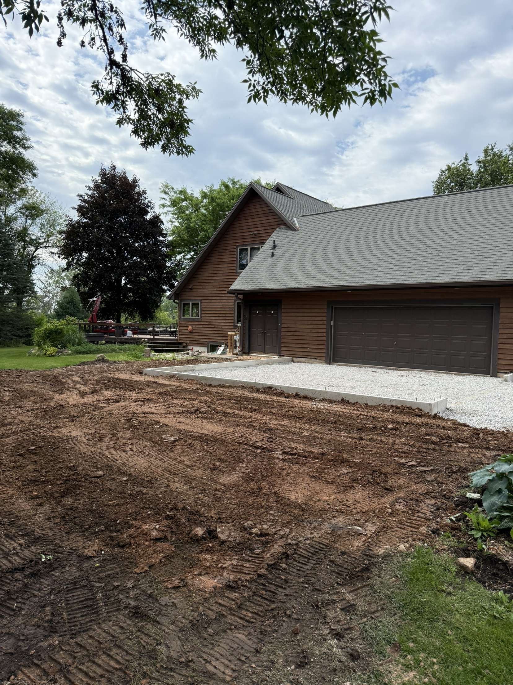 A bulldozer is digging a hole in a grassy field.