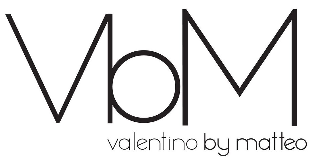 Logo con la scritta "VbM" in lettere nere stilizzate, con la scritta "valentino by matteo" sotto in un carattere sottile.