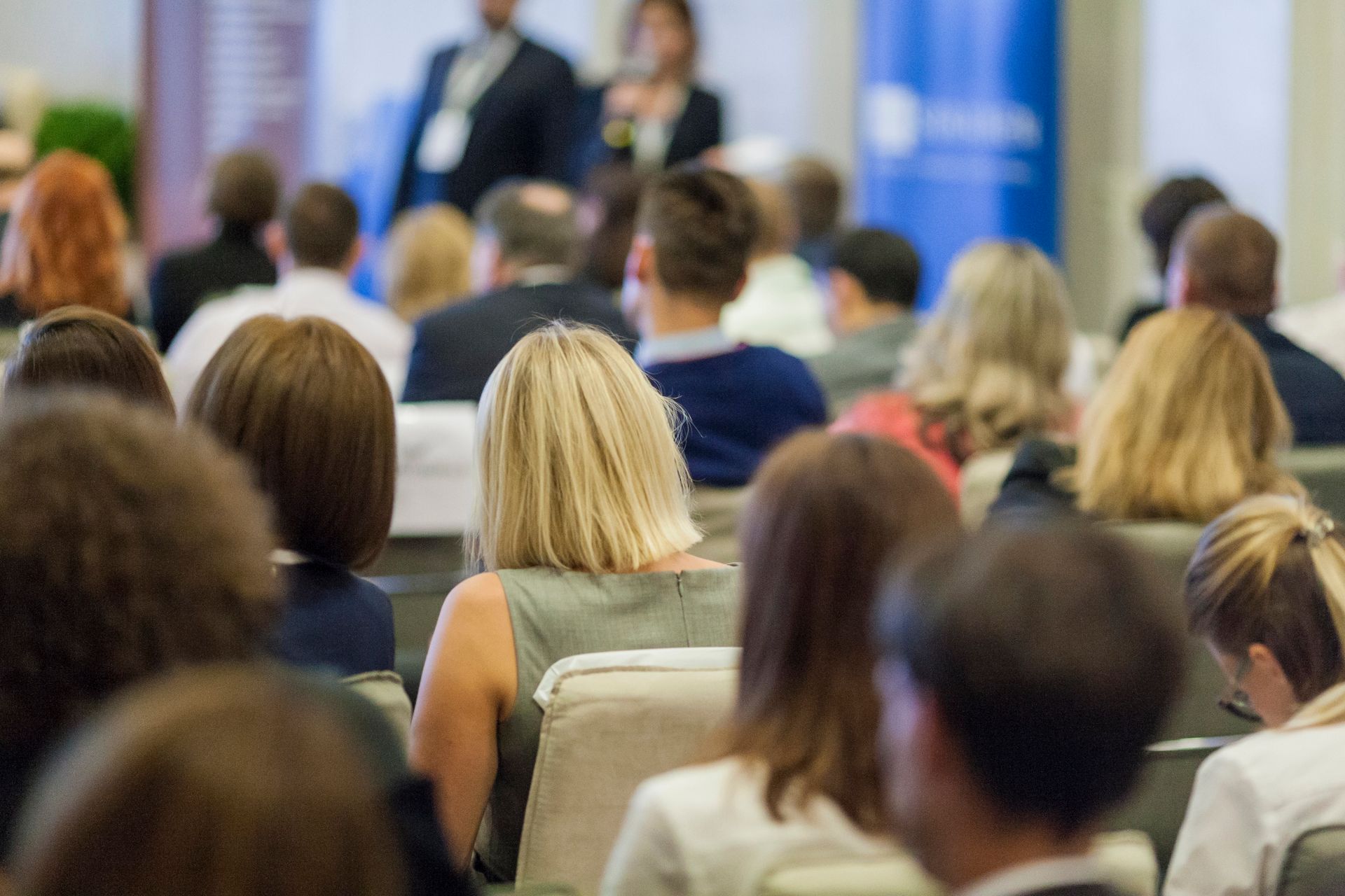 Tijdloos Coachen™ lezingen - conferentie zit met het gezicht naar een podium met sprekers. Diverse groep deelnemers.