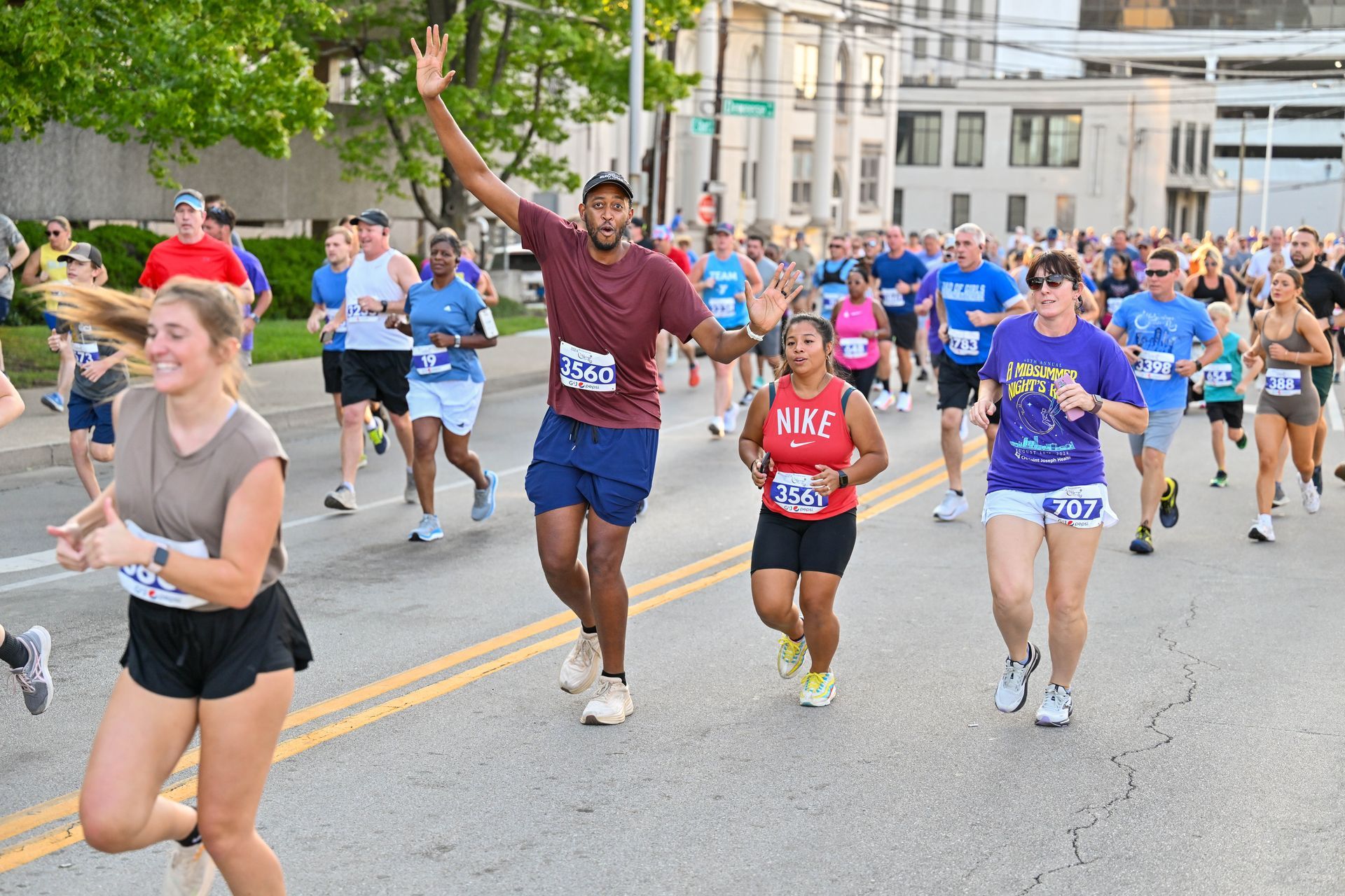 Runners at a race start under a banner that says 