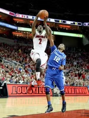 Basketball player in red jersey shoots over a defender in a blue jersey, game in Louisville.