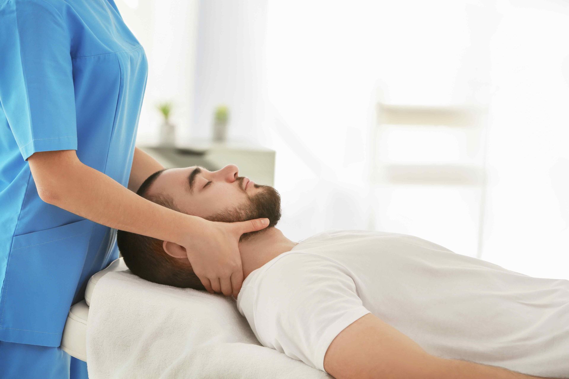 Chiropractor Feeling a Patient's Necl