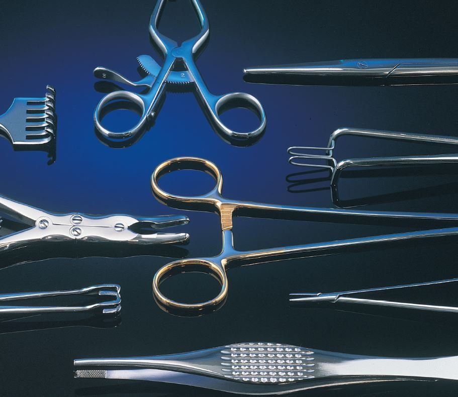 Surgical instruments including forceps, clamps, and retractors are displayed on a dark blue surface.