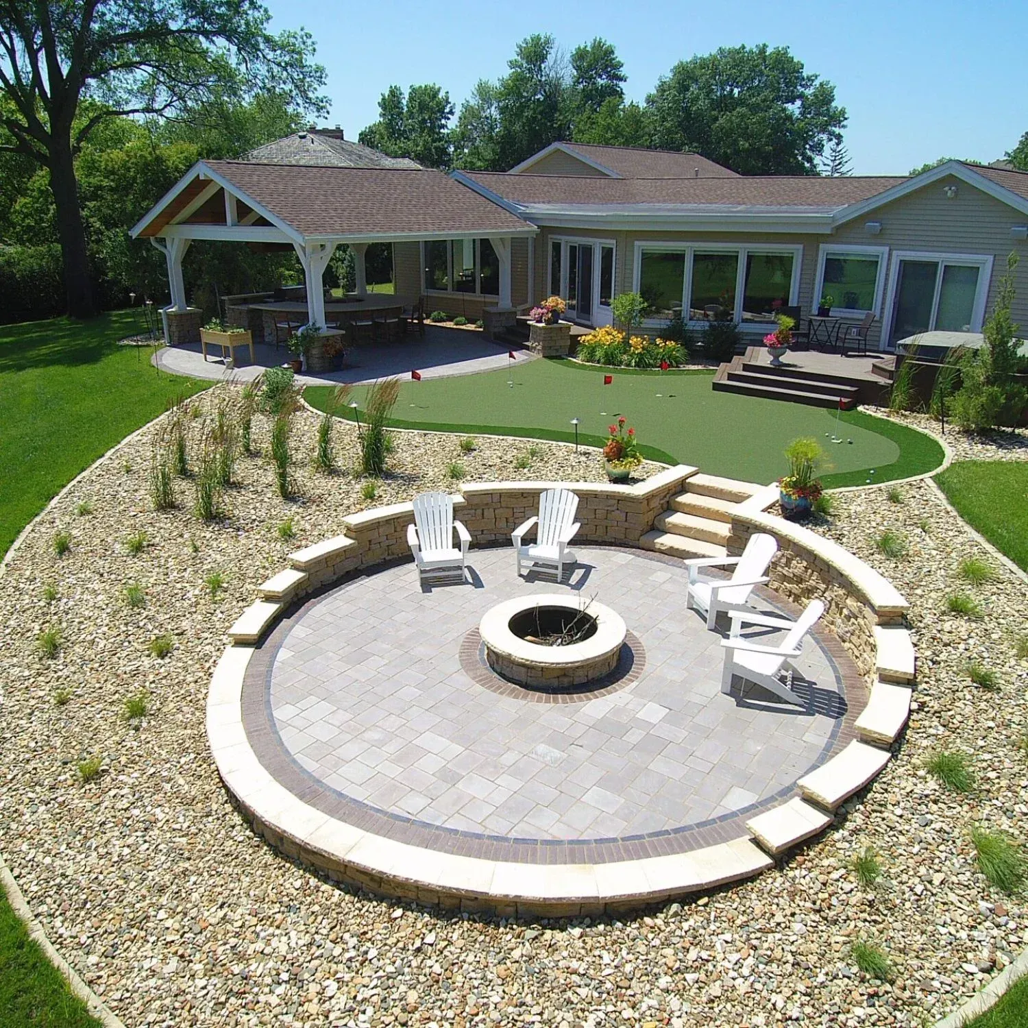 An aerial view of a backyard with a fire pit and chairs — Waterloo, IA — Matthias Landscaping Co