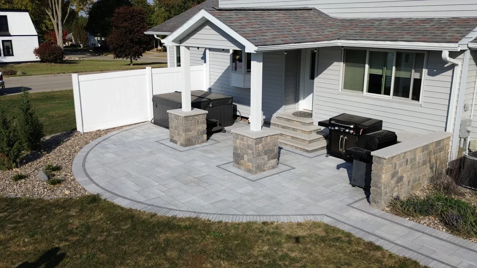 An aerial view of a house with a patio and a grill — Waterloo, IA — Matthias Landscaping Co