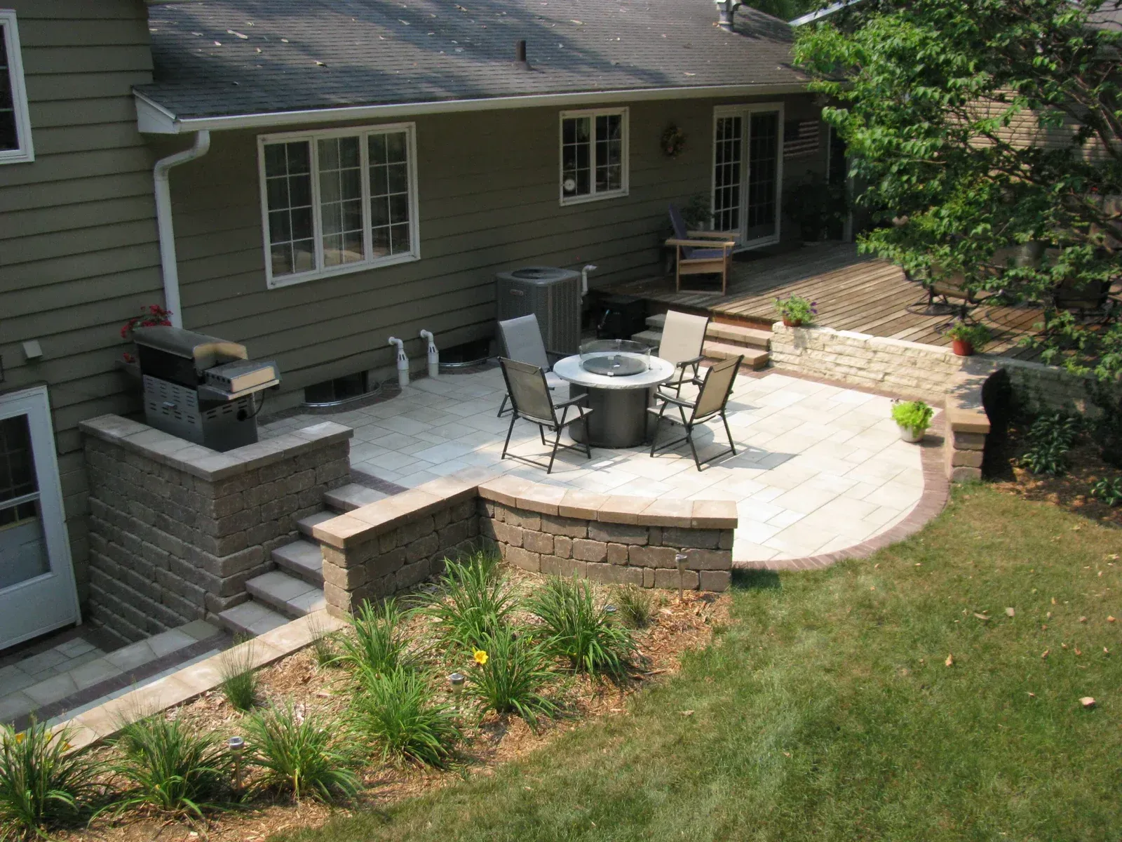 An aerial view of a house with a patio and a fire pit — Waterloo, IA — Matthias Landscaping Co