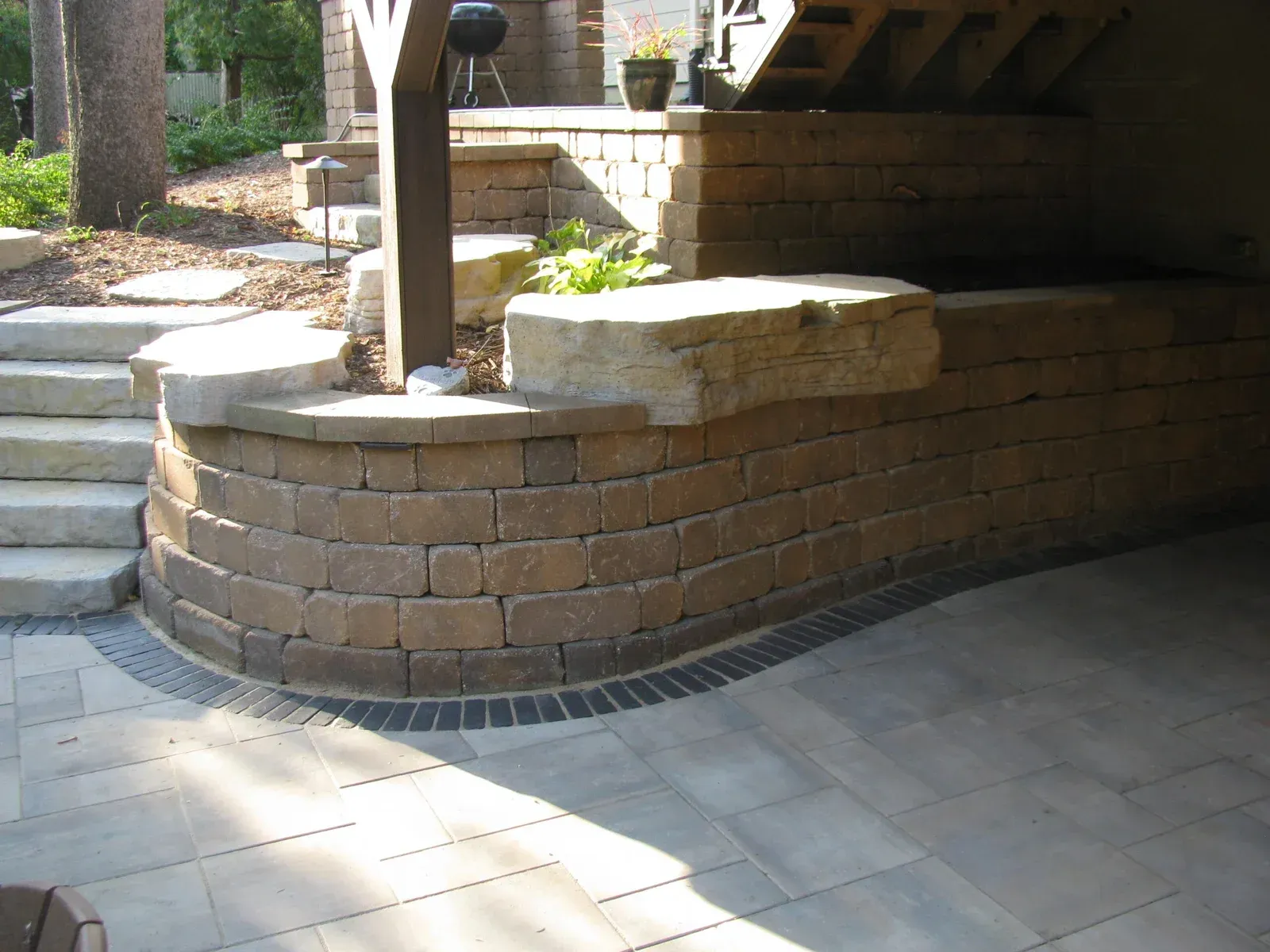 A brick wall with stairs leading up to it — Waterloo, IA — Matthias Landscaping Co