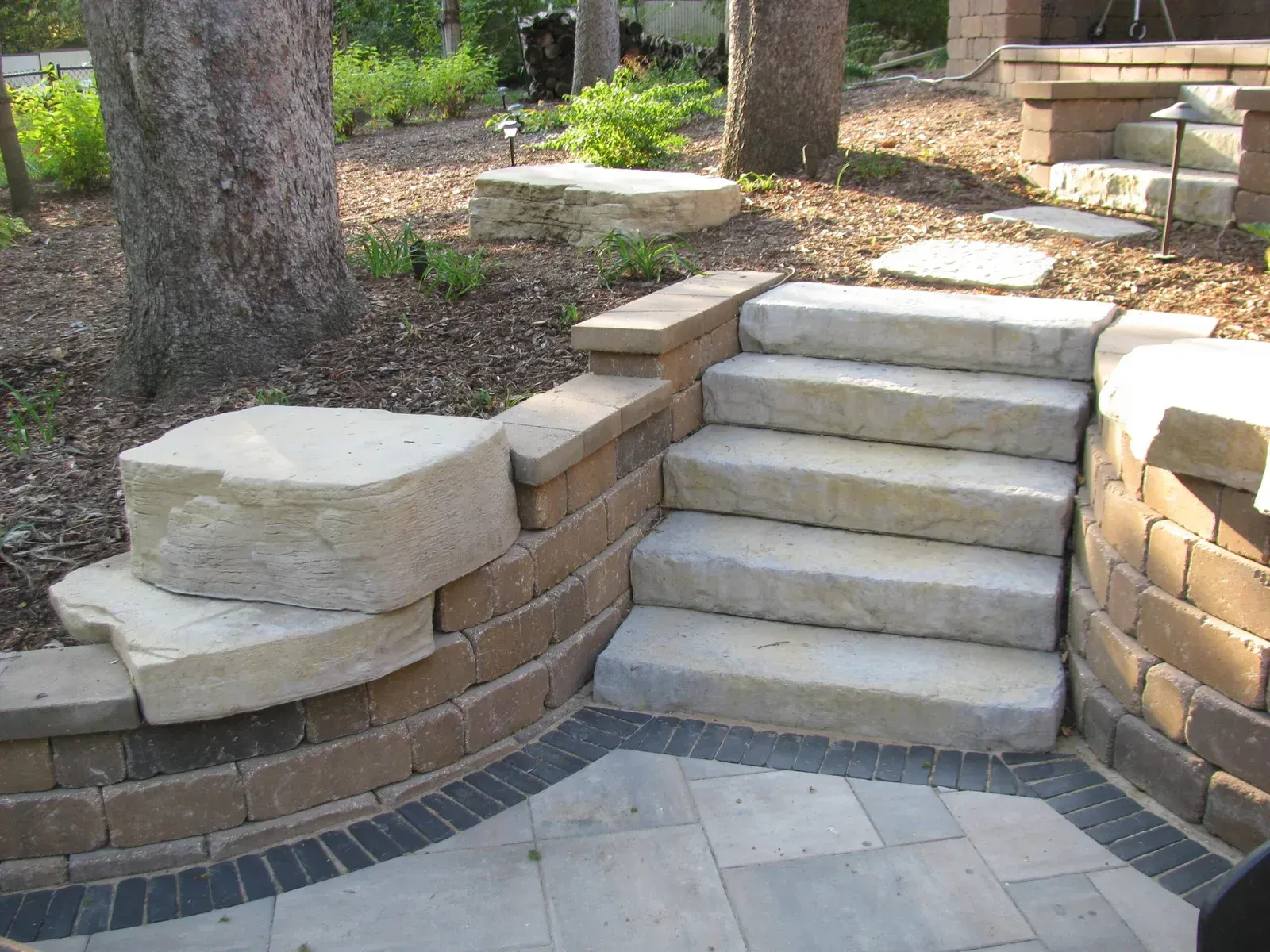 A set of stairs leading up to a brick wall — Waterloo, IA — Matthias Landscaping Co