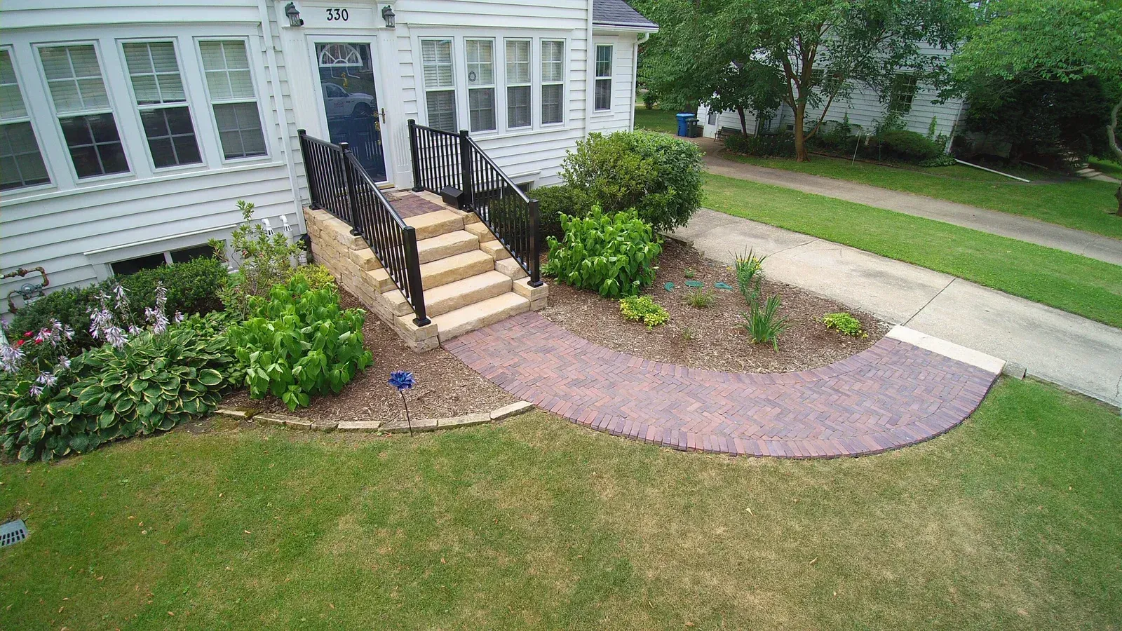 An aerial view of a house with stairs leading up to the front door — Waterloo, IA — Matthias Landscaping Co