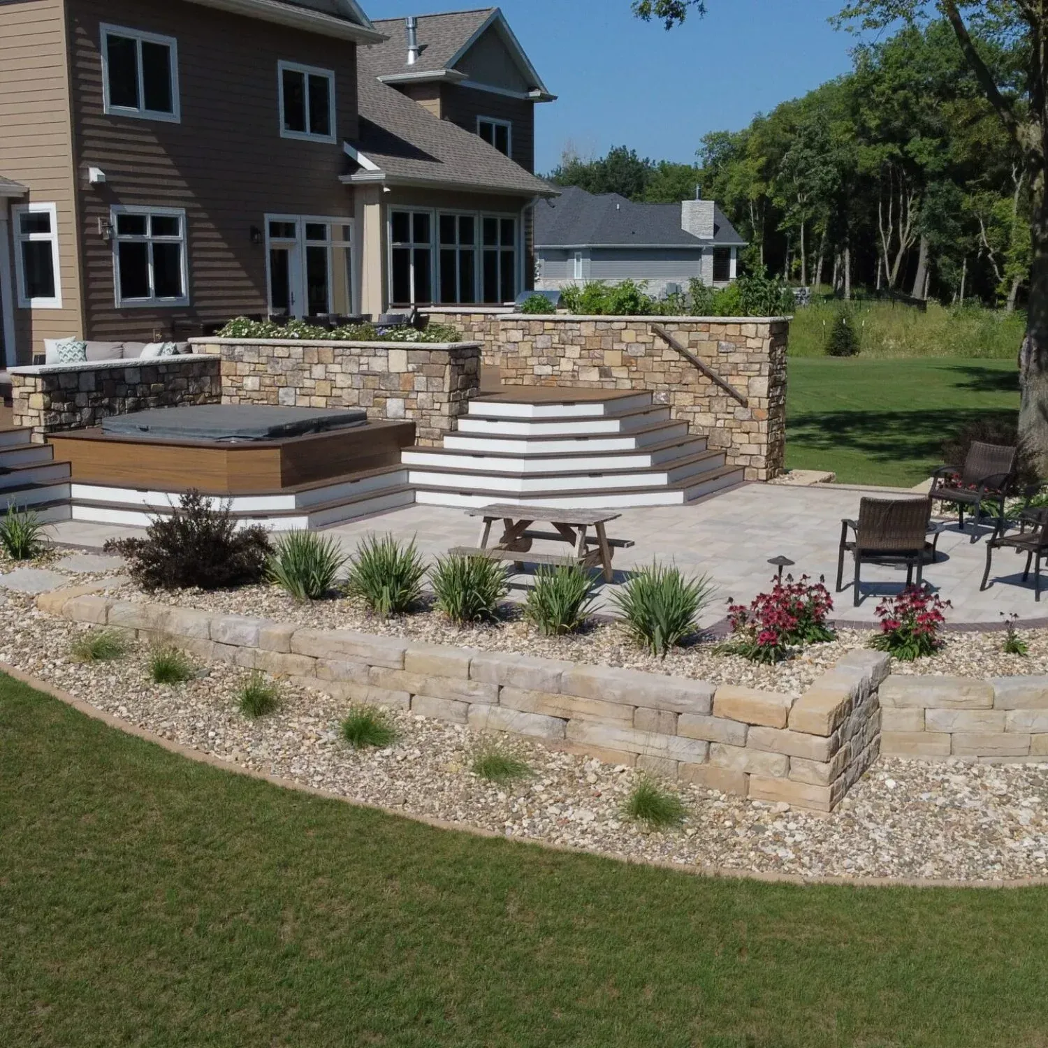 A house with a patio and stairs in front of it — Waterloo, IA — Matthias Landscaping Co