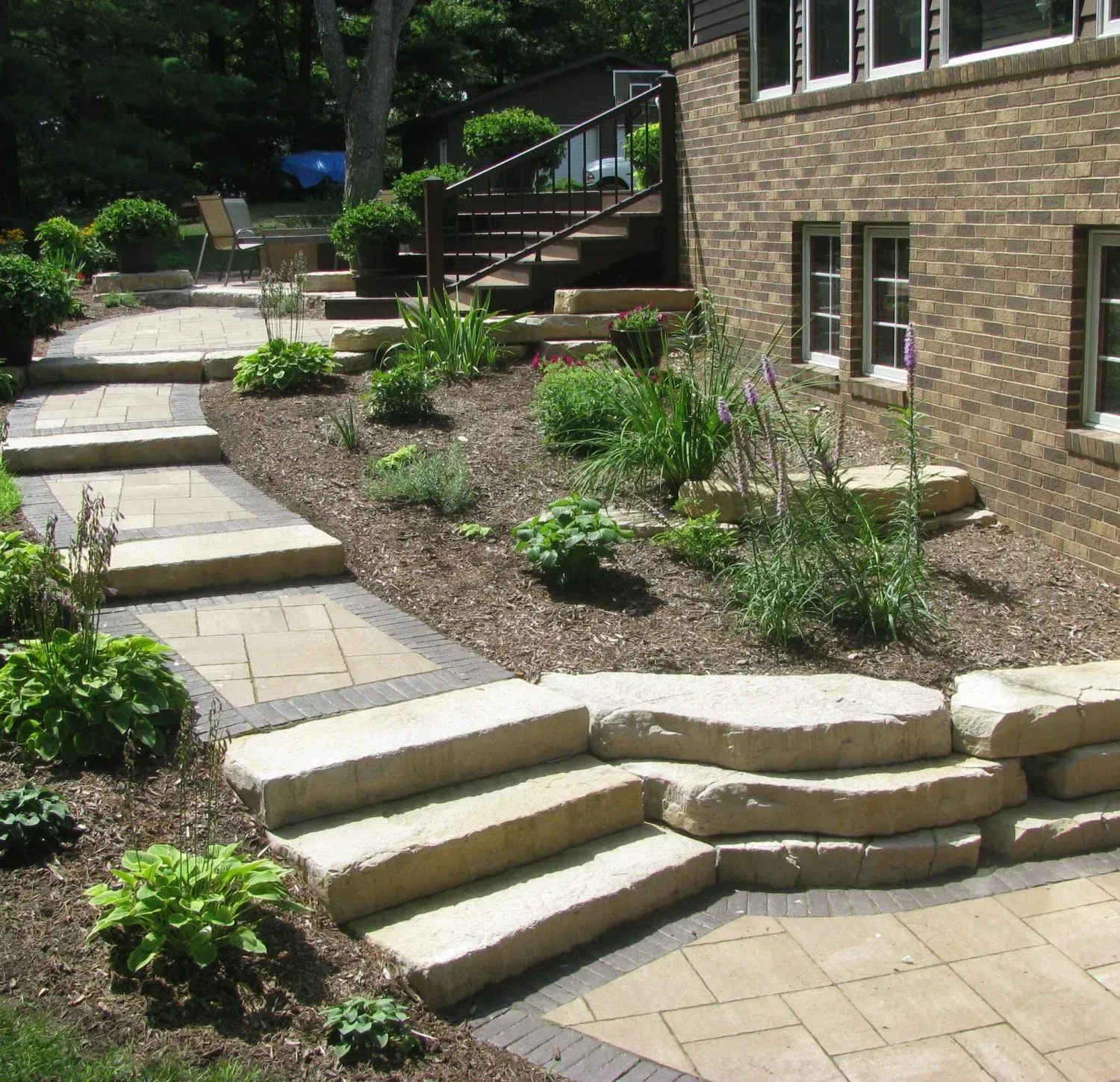 A brick house with stairs leading up to it — Waterloo, IA — Matthias Landscaping Co