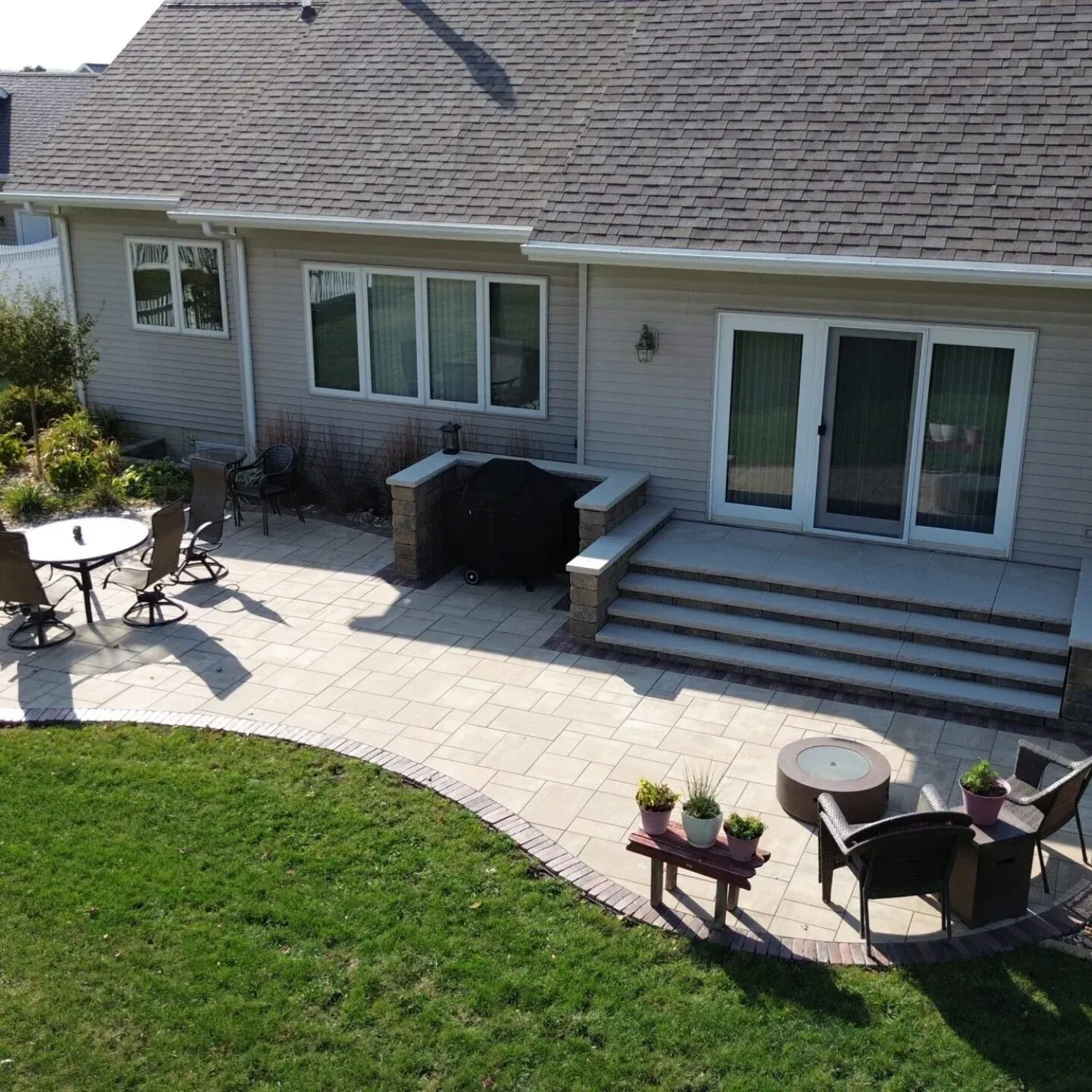 An aerial view of a house with a patio in front of it — Waterloo, IA — Matthias Landscaping Co