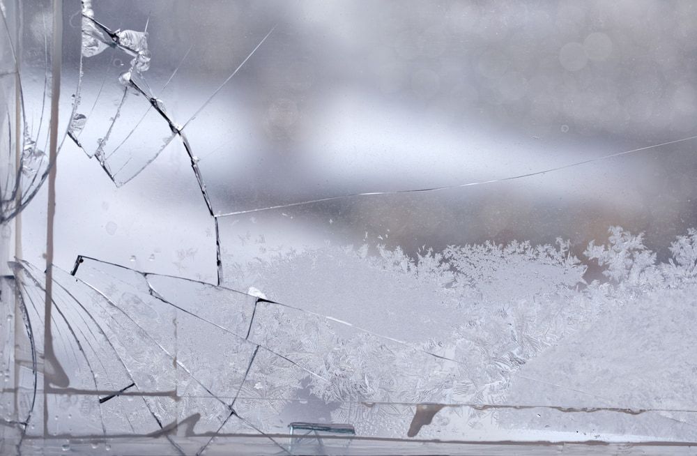 A Close Up of a Broken Glass Window With Frost on It — Twin Cities Glass In Albury, NSW