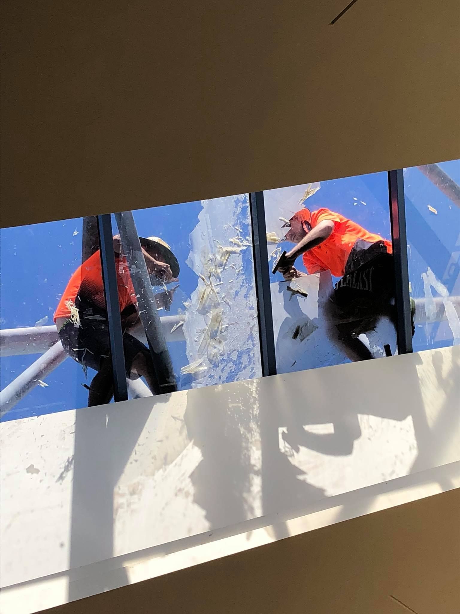 Two Men are fixing glass on a roof — Twin Cities Glass In Albury, NSW