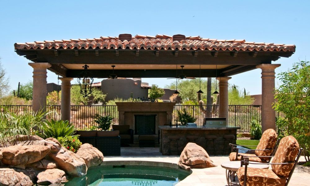 A patio with a gazebo and a swimming pool