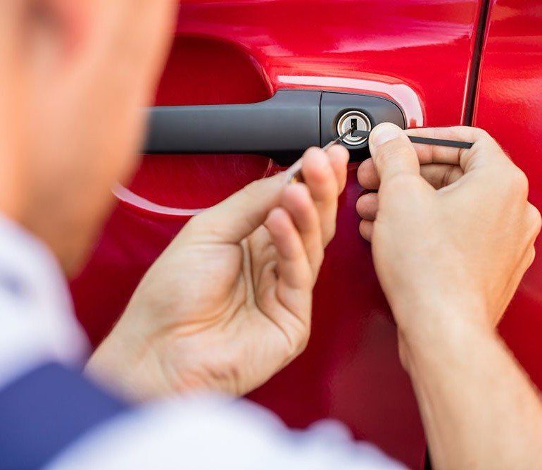 Automobile Locksmith Using Picks to Open Car Door