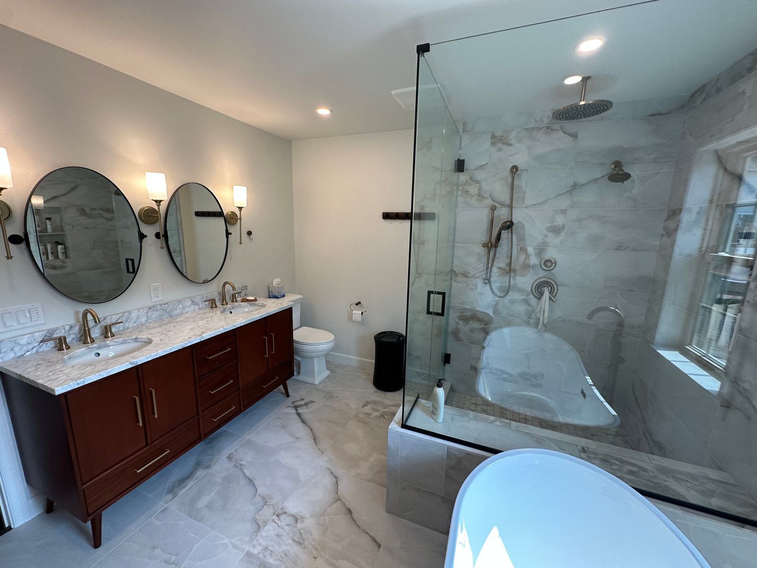 A bathroom with two sinks , a toilet , and a bathtub.